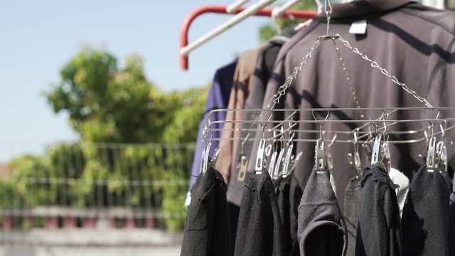 House laundry by hanging underwear pants and socks on aluminium hanger with clothes in sunny day