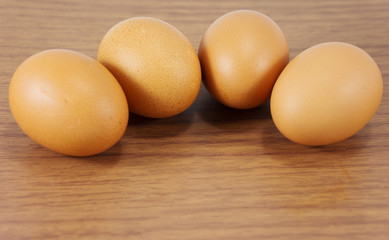 Group of organic free range chicken eggs on wood table. Fresh eggs for sale at a market. Fresh Chicken Rooster Eggs on at Local Farmer Market.