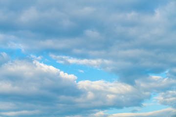 Fototapeta na wymiar Idylic blue sky with fluffy cloud sunset