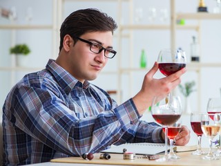Professional sommelier tasting red wine