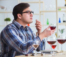 Professional sommelier tasting red wine
