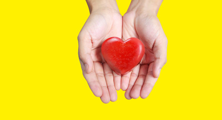 Fototapeta premium Hands holding a red heart .health donation concepts