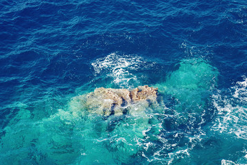 Mediterranean sea rocky shore with blue water