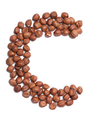 Obraz premium Letter C of the English alphabet from from hazelnut on a white isolated background. Food pattern made from nuts. Bright alphabet for shops.