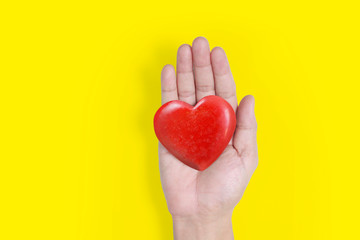 Hands holding a red heart .health donation concepts