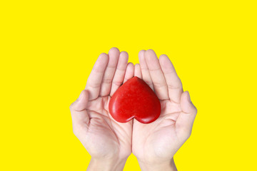 Hands holding a red heart .health donation concepts