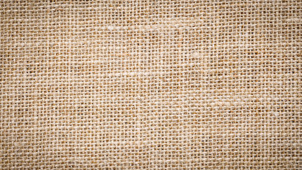 Cotton woven fabric background with flecks of varying colors of beige and brown. with copy space. office desk concept, Jute hessian sackcloth natura / Hessian sackcloth burlap woven texture background