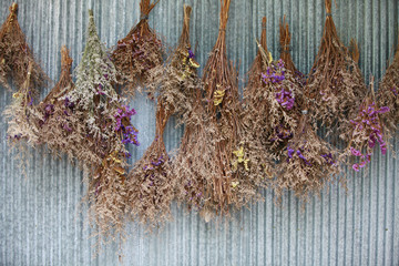 vintage dried bouquet hanging on the wall © kanpisut
