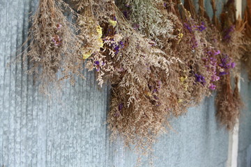 vintage dried bouquet hanging on the wall © kanpisut