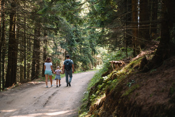 Fototapeta premium Young family with child resting on a forest