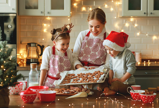 happy family mother and children bake christmas cookies.