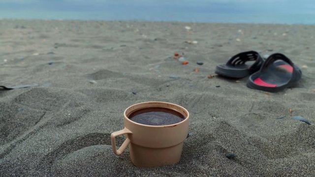 Spinning Coffee In The Plastic Cup On The Beach Of Black Sea, Georgia