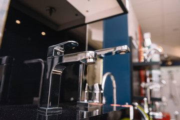 Rows of new faucets in plumbing shop, closeup