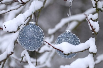 Christmas balls with beads decor on snowy branches in the winter garden background.Christmas and New Year  festive background.IPhone Wallpaper. Winter festive decor street