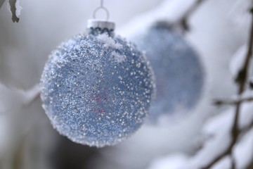 Christmas balls with beads decor on snowy branches in the winter garden .Christmas and New Year winter festive background.IPhone Wallpaper. Winter festive decor street
