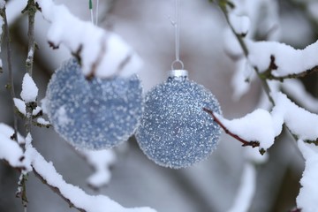 Christmas balls with beads decor on snowy branches in the winter garden background.Christmas and New Year winter festive background.IPhone Wallpaper. Winter festive decor street