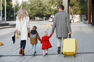 Family with yellow suitcase