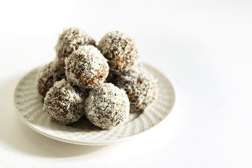 Energy balls on a white bowl on a white background