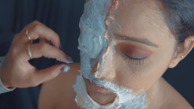 Close up of woman's face with a zombie mask for Halloween party 