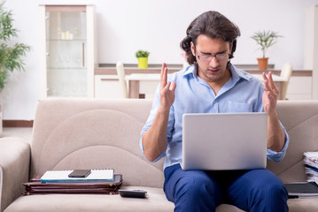 Young male employee working at home
