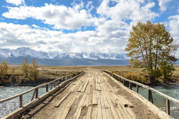 Fototapeta premium wooden bridge over a mountain river
