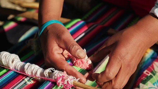 local weaver working in a colorful piece