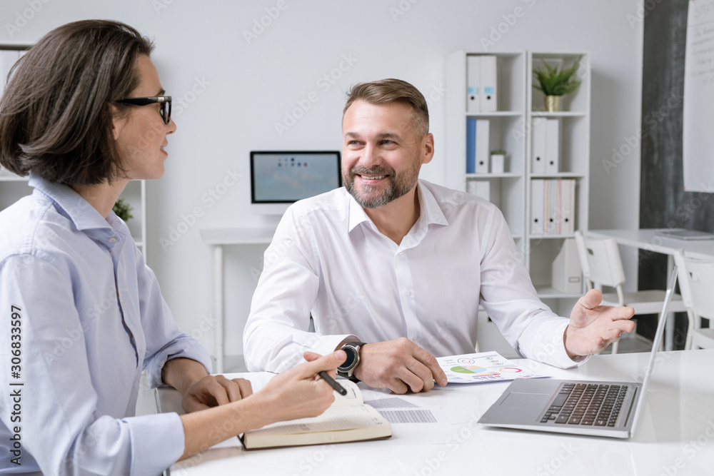 Aufkleber happy male broker pointing at laptop display while making presentation