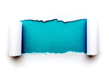 A hole in white paper with torn edges isolated on a white background with a vintage light blue color paper background inside. Good paper texture