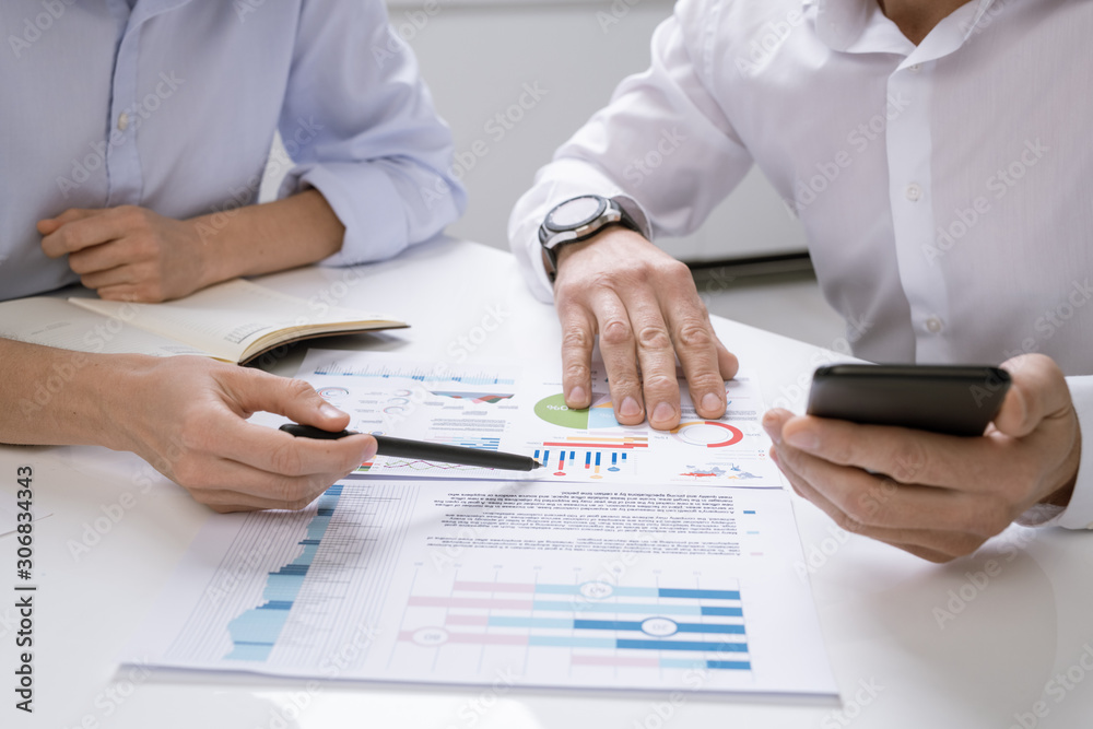 Aufkleber one of successful economists pointing at financial chart on paper