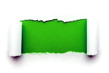 A hole in white paper with torn edges isolated on a white background with a bright green color paper background inside. Good paper texture