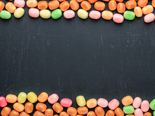 frame of multi-colored candies on a dark background with copy space - 306834508