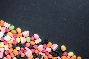 frame of multi-colored candies on a dark background with copy space - 306834516