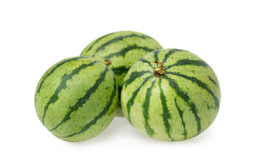 Closeup group of three small striped whole watermelons isolated at white background.