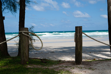 The wooden post was built as a rope gate at night. For the safety and privacy of guests at a beach resort.