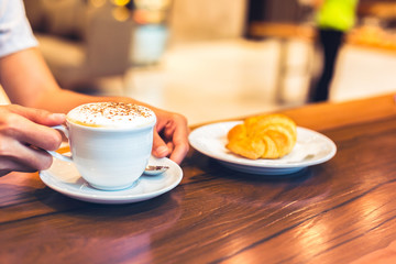 Cup of coffee on the table in the morning.