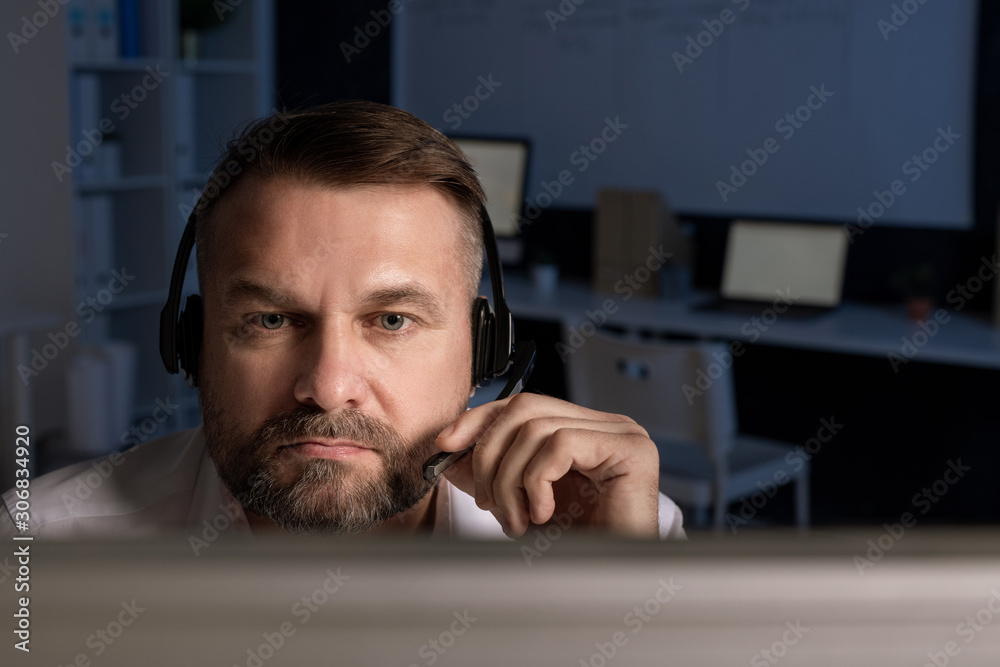 Poster confident customer support representative with headset speaking in microphone
