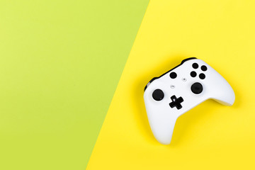 White joystick gamepad, game console on yellow background. Computer gaming technology play competition videogame control confrontation concept. Cyberspace symbol