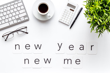 Plan concept. New year new me - motivation motto on white office desk top-down