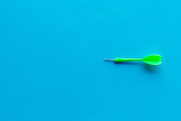 Plastic dart or arrows for darts game on blue background top view copy space