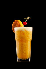 Closeup glass of fresh orange juice shake decorated with winter cherry isolated at black background.
