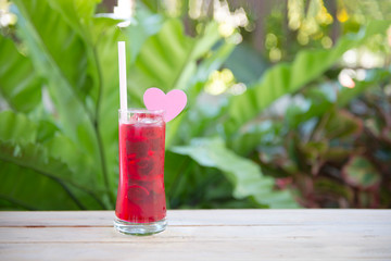 A glass of red juice with ice