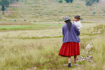 Native american woman with little boy in the countryside.