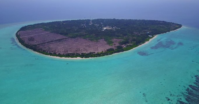 Tropical Paradise Of Green Trees Surrounded By Bright Blue Ocean Water - An Exotic Tourist Destination Thoddoo, Maldives - Aerial Shot