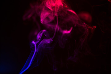 Fototapeta premium Colorful smoke close-up on a black background