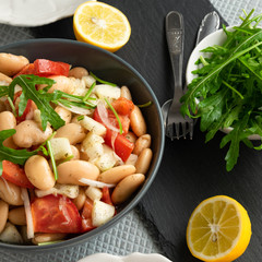 Ready to eat beans salad, healthy protein rich meal with fresh arugula leaves
