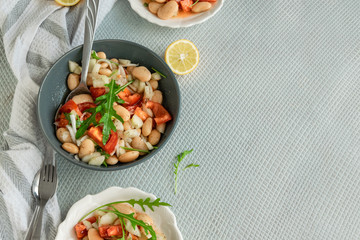 Ready to eat beans salad, healthy protein rich meal with fresh arugula leaves