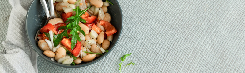 Ready to eat beans salad, healthy protein rich meal with fresh arugula leaves