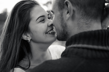 low contrast image of a happy romantic young couple spending time outdoor in the autumn park