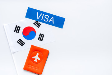 Visa to Korea concept. Korean flag near passport on white background top-down copy space