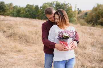 Beautiful young couple walking in autumn park.